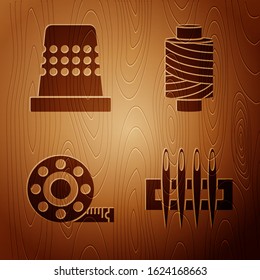Set Needle for sewing, Thimble for sewing, Tape measure and Sewing thread on spool on wooden background. Vector