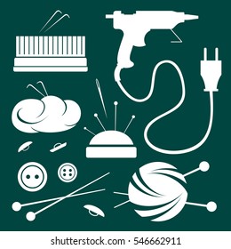 Set needlework accessories. Glue gun, yarn, buttons, knitting needles, pins, needle for sewing, needles and wool for felting.