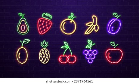 A set of neon bright fruits avocado, strawberry, orange, banana, plum, lemon, pineapple, cherry, grape and apple on the background of a brick wall.