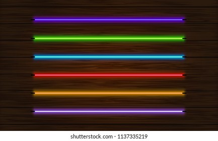 A set of neon brushes. Set of colorful light objects on a dark tree background.