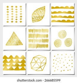 A set of nine abstract geometric designs in white and golden. Brush strokes, doodles, organic patterns and shapes.