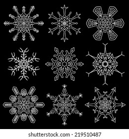 Set of nine beautiful drawn snowflake silhouettes
