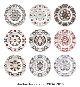 Set of nine decorative plates with a circular colored pattern, top view. White background. Vector illustration.