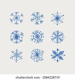 Set of nine vector blue snowflakes on white background. Hand drawn winter snowflake silhouettes. Perfect design elements for holiday design projects. Christmas and happy new year vector design.