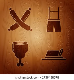 Set Oktoberfest hat, Crossed sausage, Chicken leg and Lederhosen on wooden background. Vector