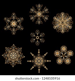 set of openwork snowflakes of gold metallic color. Element for Christmas design