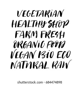 Set of organic phrases. Vegan, vegetarian, healthy, farm fresh, organic, bio, eco, natural, raw, food, shop. Ink illustration. Modern brush calligraphy. Isolated on white background.
