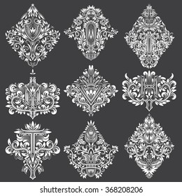 Set of ornamental elements for design. White floral decorations on black. Isolated tattoo patterns in vintage baroque style.