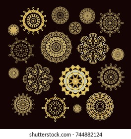 Set of ornamental golden vector rosettes-snowflakes on dark background