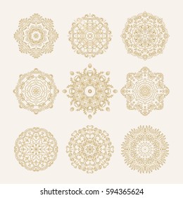 Set of ornamental vector golden rosettes, snowflakes, mandala