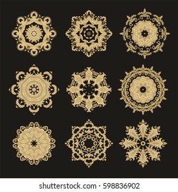 Set of ornamental vector golden rosettes on dark background 