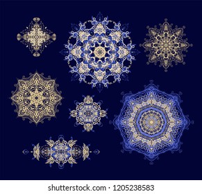Set of ornamental vector rosettes - snowflakes on  dark background