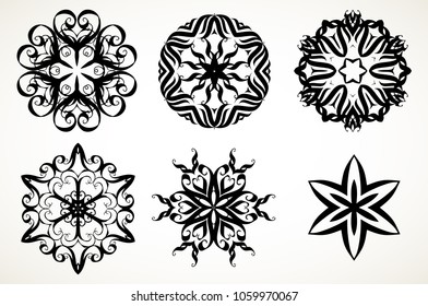 Set of ornate lacy doodle floral round rosettes in black over white backgrounds. Mandalas formed with hand drawn calligraphic elements.