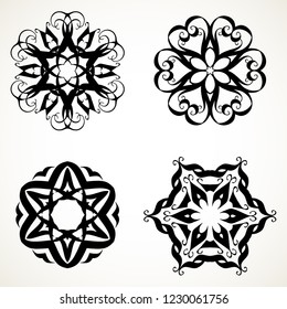 Set of ornate lacy doodle floral round rosettes in black over white backgrounds. Mandalas formed with hand drawn calligraphic elements.