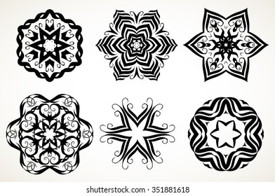 Set of ornate lacy doodle floral round rosettes in black over white backgrounds. Mandalas formed with hand drawn calligraphic elements.