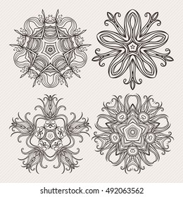 Set of ornate vector mandala symbols. Mehndi lace tattoo. Art Nouveau weave. The circular pattern.