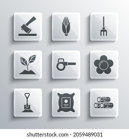 Set Pack full of seeds of plant, Wooden logs, Flower, Leaf garden blower, Shovel in the ground, Plant, axe and Garden rake icon. Vector