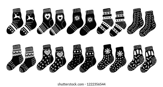 Set from pairs of hand drawn cute warm socks on white background. Black and white vector illustration.