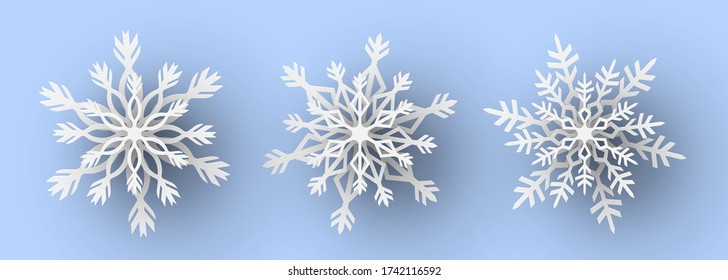 Juego de copos de nieve cortados con papel. Ilustración vectorial.