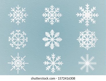 set of paper snowflakes on blue blackground