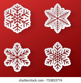 Set of paper snowflakes on red background. Vector.