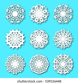 Set paper snowflakes with shadow, isolated on a blue background. Graphic material and design elements to decorate Christmas cards,  posters, vector illustration.