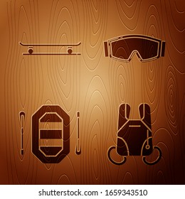 Set Parachute, Skateboard, Rafting boat and Ski goggles on wooden background. Vector