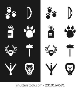 Set Paw print, Camping gas stove, Bow, Deer antlers on shield, Road traffic sign, Bear head and Bird footprint icon. Vector