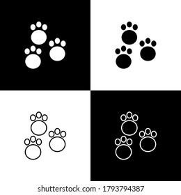 Set Paw print icon isolated on black and white background. Dog or cat paw print. Animal track. Vector