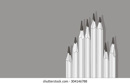 a set of pencils on gray background