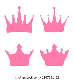 Set of pink crowns on a white background