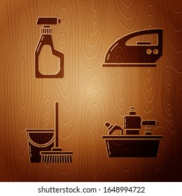 Set Plastic bottles for liquid dishwashing liquid, Cleaning spray bottle with detergent liquid , Mop and bucket  and Electric iron  on wooden background. Vector