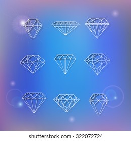 Set of polygonal diamonds on blur blue background with flare can be used as elements of design for logos creation