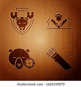 Set Quiver with arrows, Moose head on shield, Hunt on bear with crosshairs and Trap hunting on wooden background. Vector