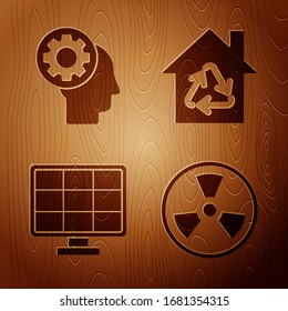 Colocar la cabeza radiactiva, humana con engranaje en el interior, panel de energía solar y Eco House con símbolo de reciclaje sobre fondo de madera. Vector