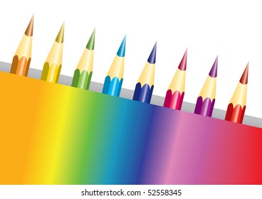 Set of rainbow colored pencils in a multicolored box isolated over white