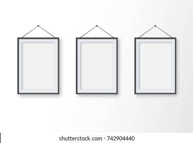 Set of realistic empty vertical blank pictures frame at light background. Mock up template for your design or modern interior. Photo frames hanging on the wall. Vector illustration