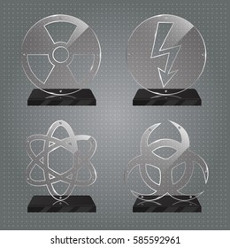 Set of realistic transparent glass trophy awards standing on black base and isolated on gradient background. Different shapes provided. Radiation, biohazard, atom, electricity. Vector illustration.