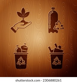 Set Recycle bin with recycle symbol, Plant in hand of environmental protection, Recycle bin with recycle symbol and Recycling plastic bottle on wooden background. Vector