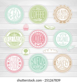 Set of retro badges on a wood background. Hand-drawn lettering and elements. Creative colored handmade food labels with inscriptions in vintage style. 