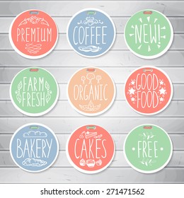 Set of retro badges on wooden background. Vintage food labels. Hand-drawn lettering. Set of creative colored handmade food labels with inscriptions