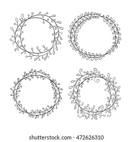 Set of round frames, hand-drawn. Round frame made of branches with leaves and berries. Wreath painted by hand.