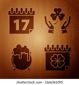Set Saint Patricks day with calendar, Saint Patrick's day with calendar, Witch cauldron and Human hands holding four leaf clover on wooden background. Vector