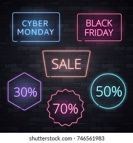 Set of sale signs neon frame light electric banners glowing on black brickwall background.Black friday Cyber monday 70 50 30 sale billboards