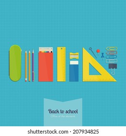set of school supplies lying in a row on a blue sheet in the box