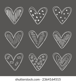 Set of scribble hearts drawn with chalk on a black board. Hearts collection with decoration. Love symbol illustration. Set of hearts in doodle style.