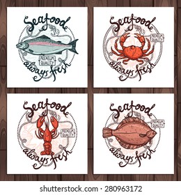 Set Of Seafood Labels, Premium Quality Always Fresh. Posters With Salmon, Crab, Lobster, Flounder, Rope And Anchor On Wooden Background
