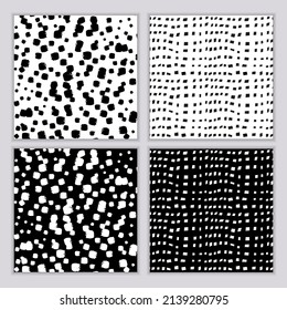Eine Reihe nahtloser abstrakter monochromer Muster. Schwarz-Weiß-Druck mit gewellten Linien, Punkten und Flecken. Pinselstriche werden handgezeichnet. Vektorstruktur