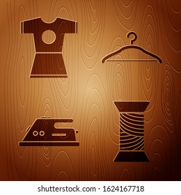 Set Sewing thread on spool, Woman dress, Electric iron and Hanger wardrobe on wooden background. Vector