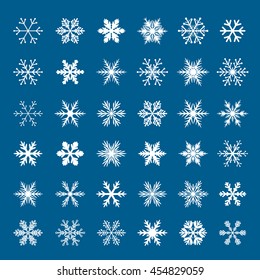 Set of shape white snowflakes on blue background. Vector isolated icons. Winter stars. Christmas decoration.